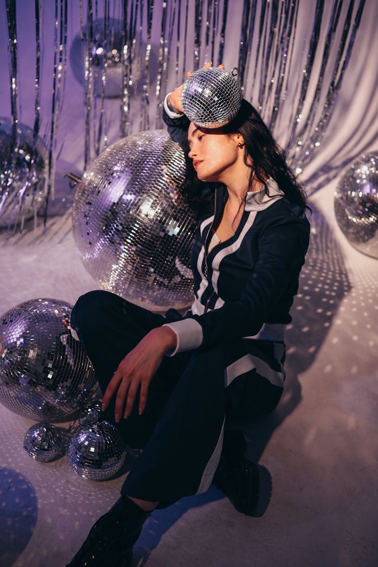 Woman In Tracksuit Posing Near Disco Balls