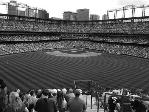 Grayscale Photo of People Watching a Baseball Game
