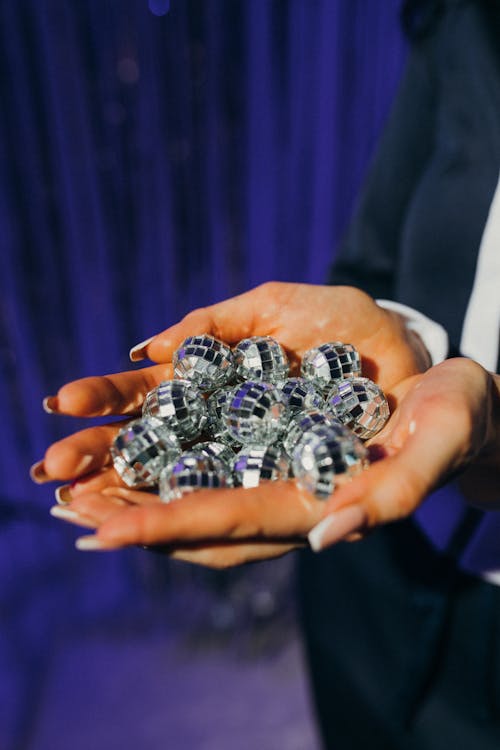 Photograph of Disco Balls on a Person's Hands