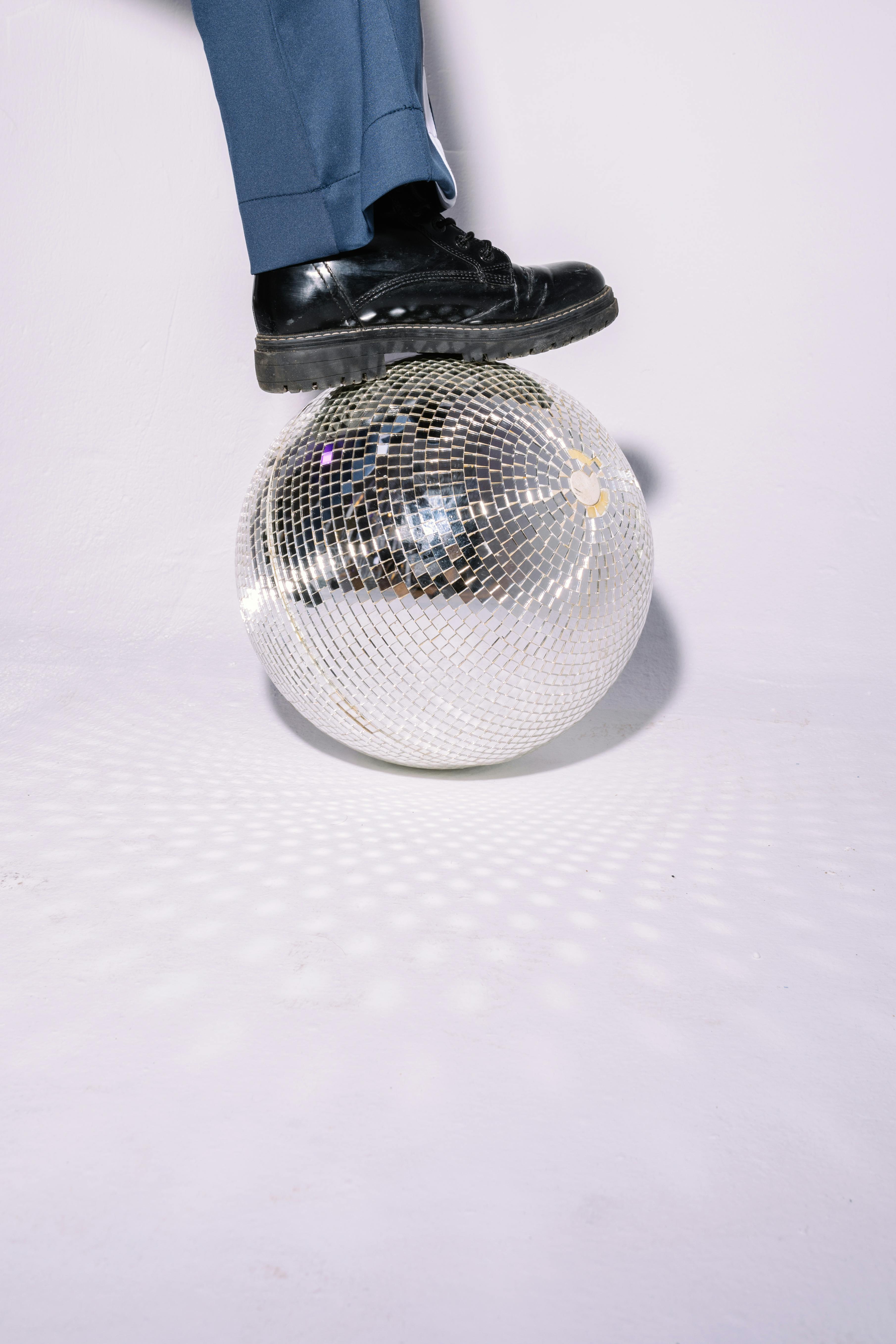 photo of a person stepping on a disco ball