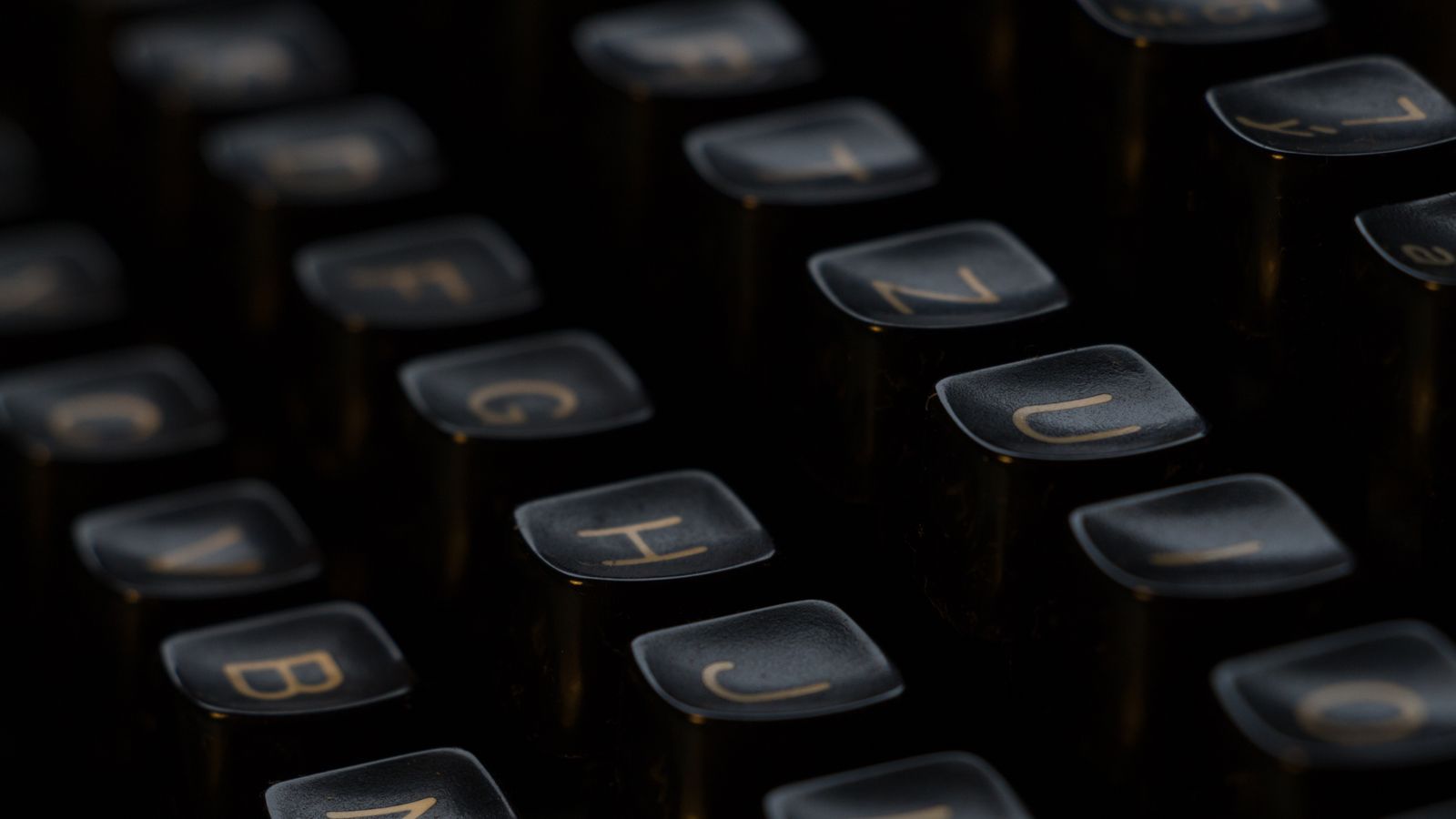 Close-up of vintage typewriter keys in a dark room