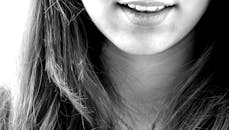 Woman Smiling in Grayscale Photography