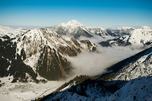 Free Rocky Mountain With Fog in Daytime Photo Stock Photo