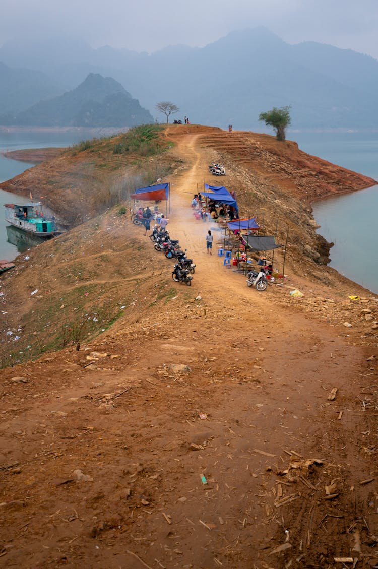 Rows Of Motorbikes Parked On Dirt Road On Hill