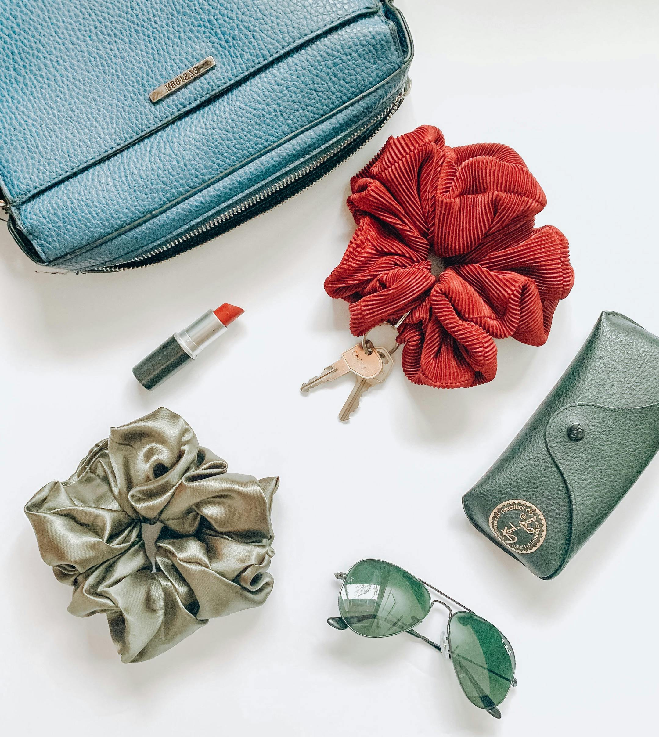 Red Flower Beside Blue Leather Pouch