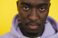 Crop black man staring at camera in studio