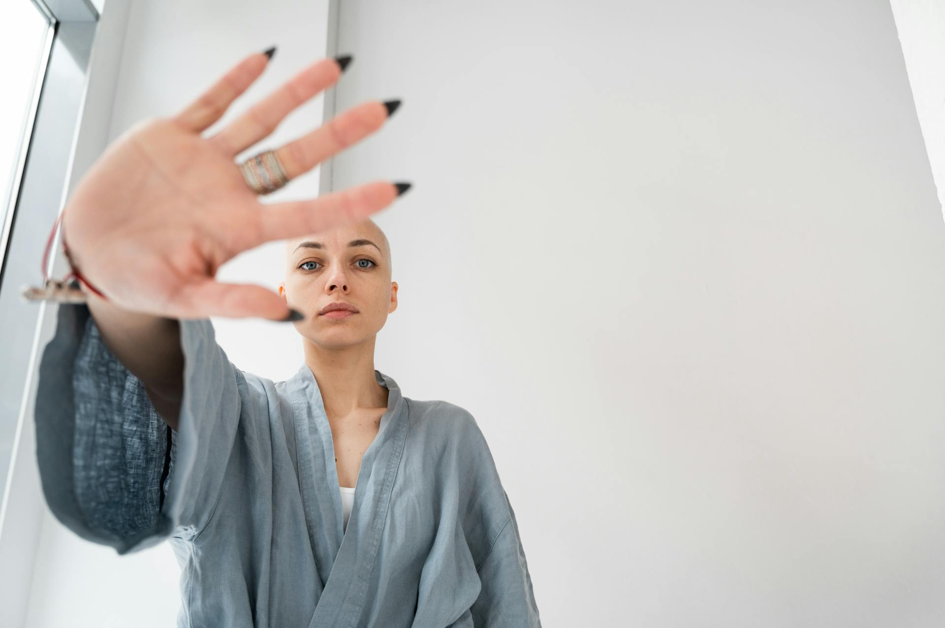 Patient showing stop gesture in light clinic