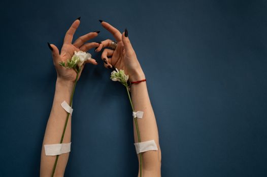 Crop anonymous female patient with blossoming flowers and medical patches for dropping medical liquid during therapy