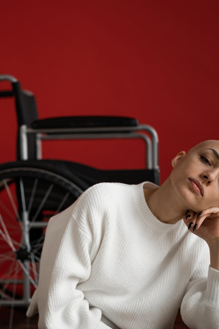 Crop Woman Touching Face Against Wheelchair