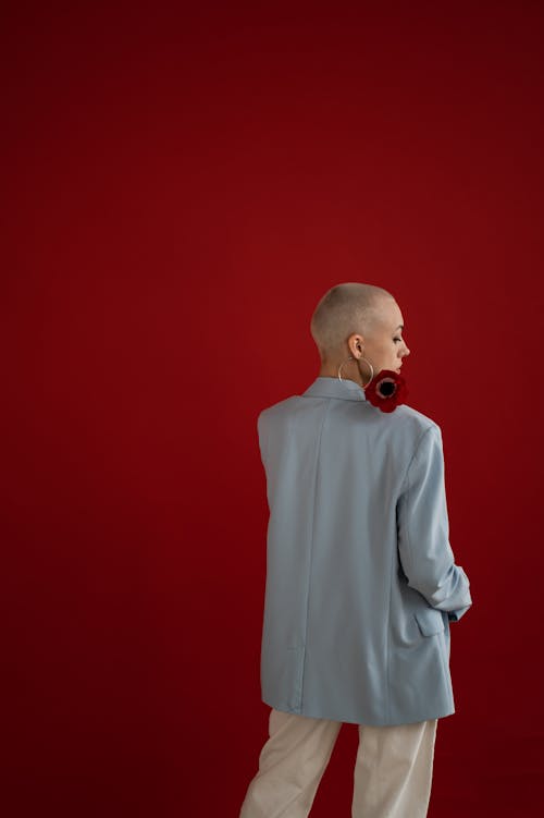 Faceless stylish woman with flower in studio