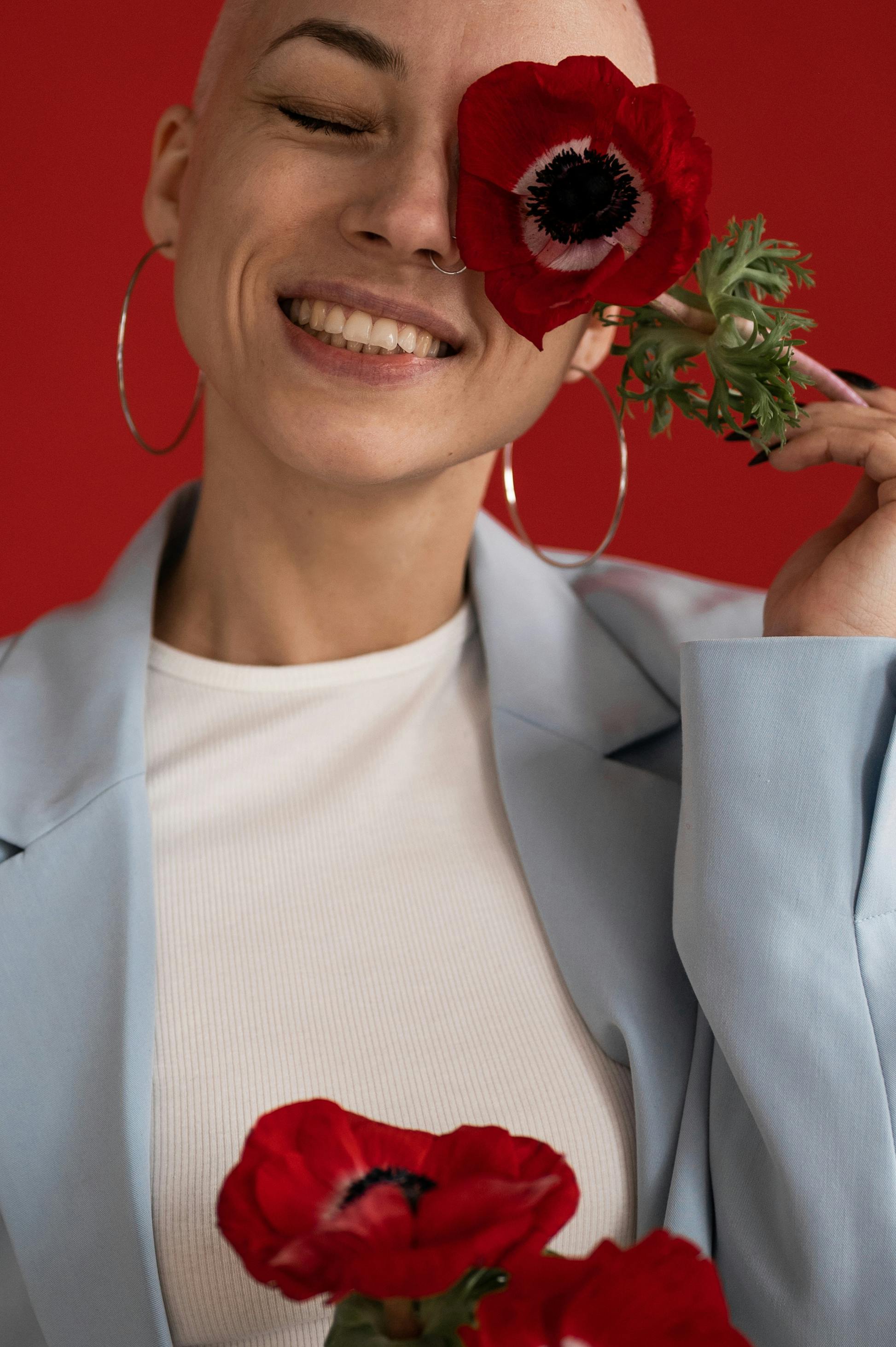 happy stylish woman with red flower