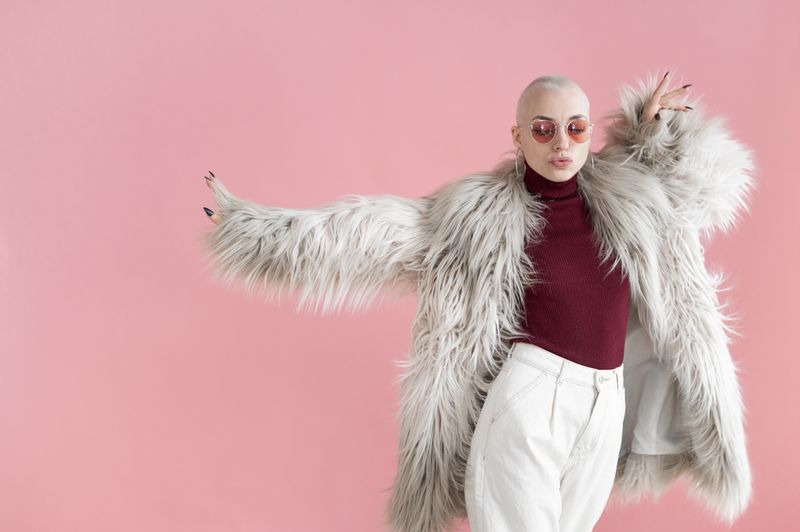 Woman in fur coat dancing in a studio