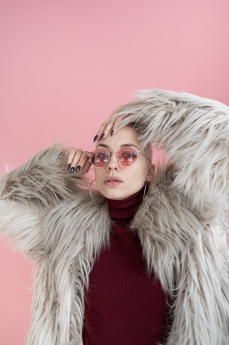 Stylish Woman Wearing Fur Coat In Studio