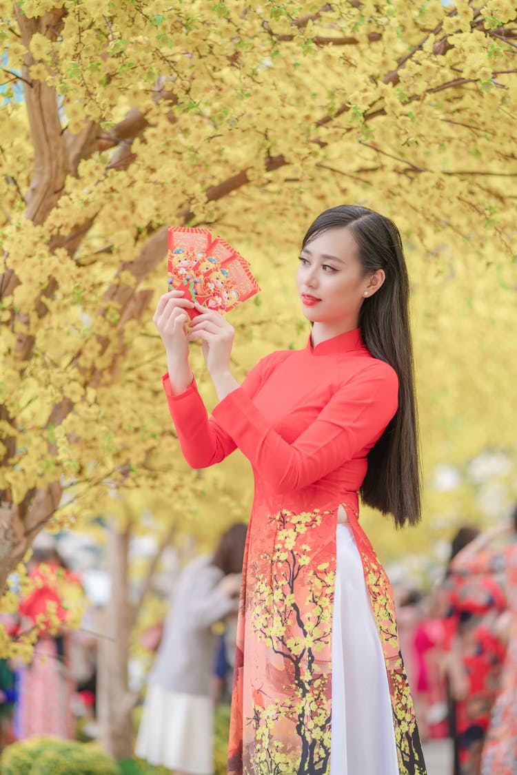 Woman In A Red Dress Holding Red Envelopes