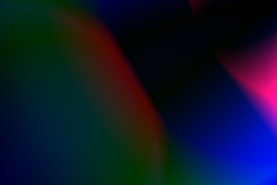 A vibrant abstract gradient with flowing colors including blue, green, pink, and red.