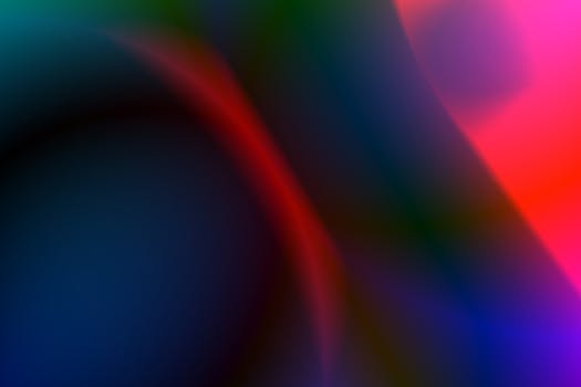 A dynamic and colorful abstract gradient background with flowing hues of red, blue, and green.