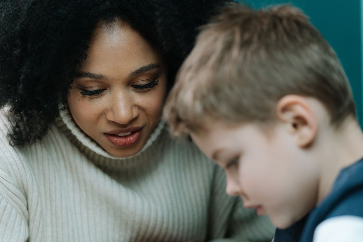 Professional nanny reading with a young child