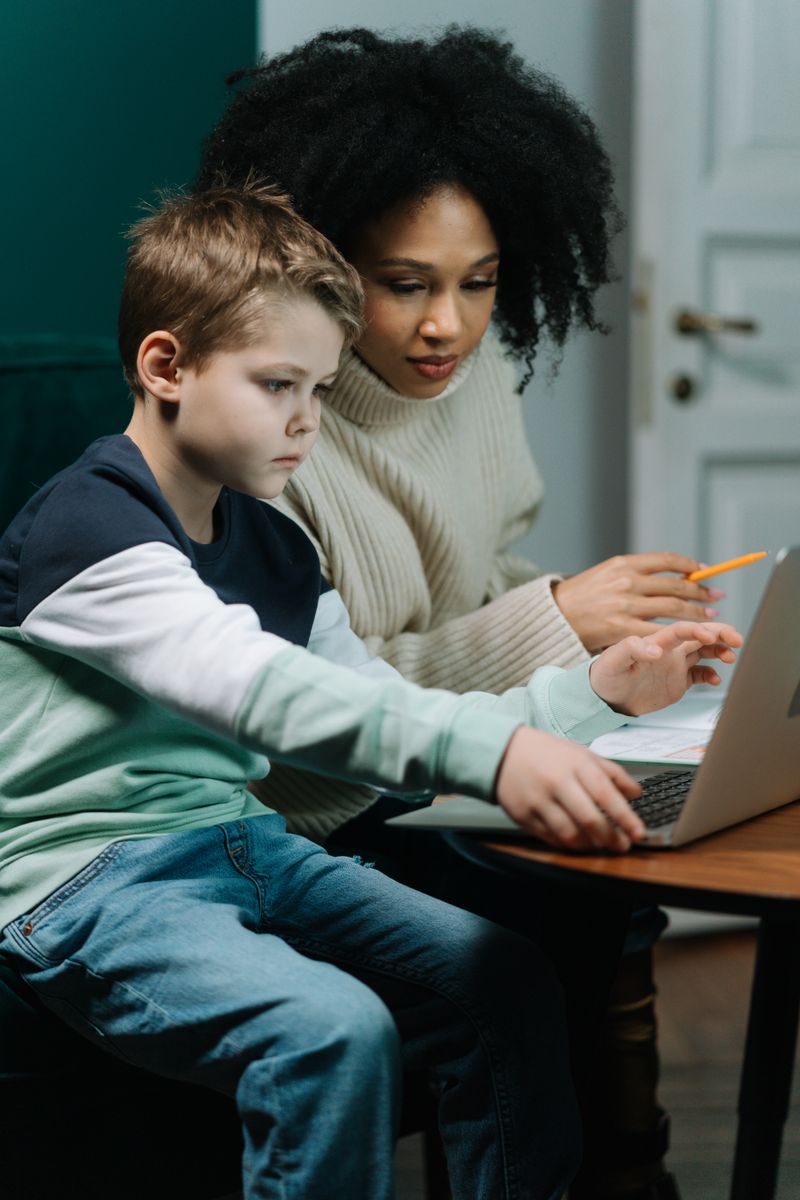 Parent tracking a child's learning progress on a laptop