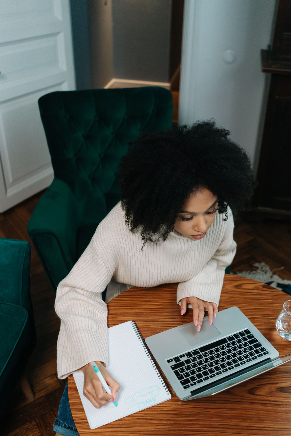 Person planning written content beside a laptop
