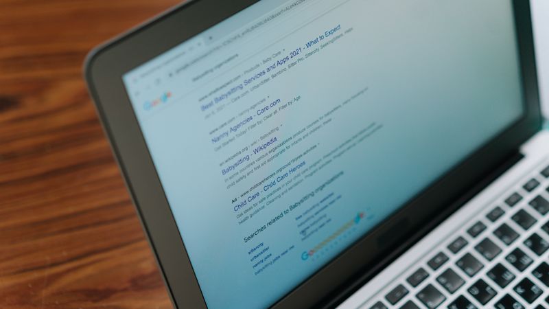 A close-up view of a laptop displaying a search engine page.