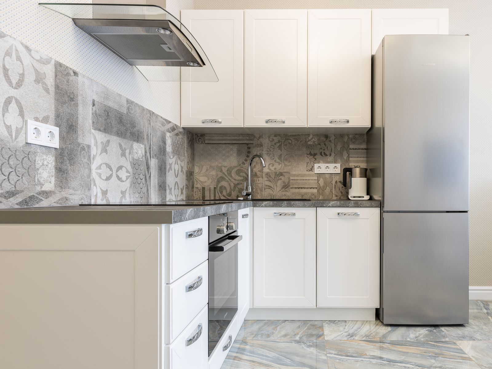 Refrigerator in a modern kitchen during fridge cooling diagnosis in JVT Dubai