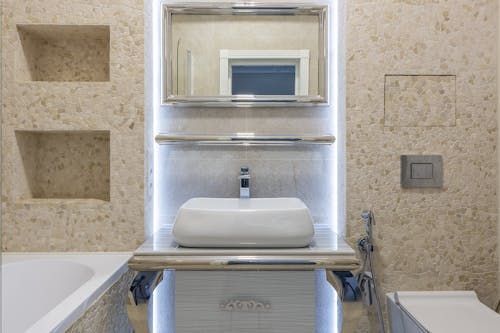Creative design of bathroom with washbasin under mirror in house