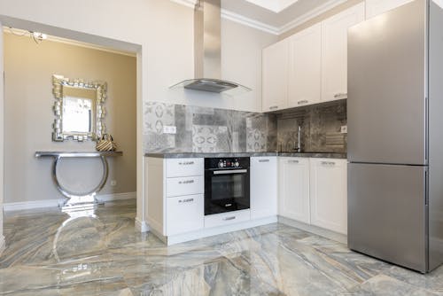 Modern kitchen interior with cabinets and refrigerator at home