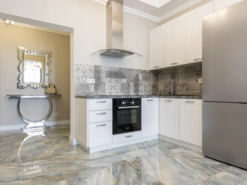 Contemporary kitchen with built-in refrigerator, oven and marble floor Contemporary kitchen with built-in refrigerator, oven and marble floor