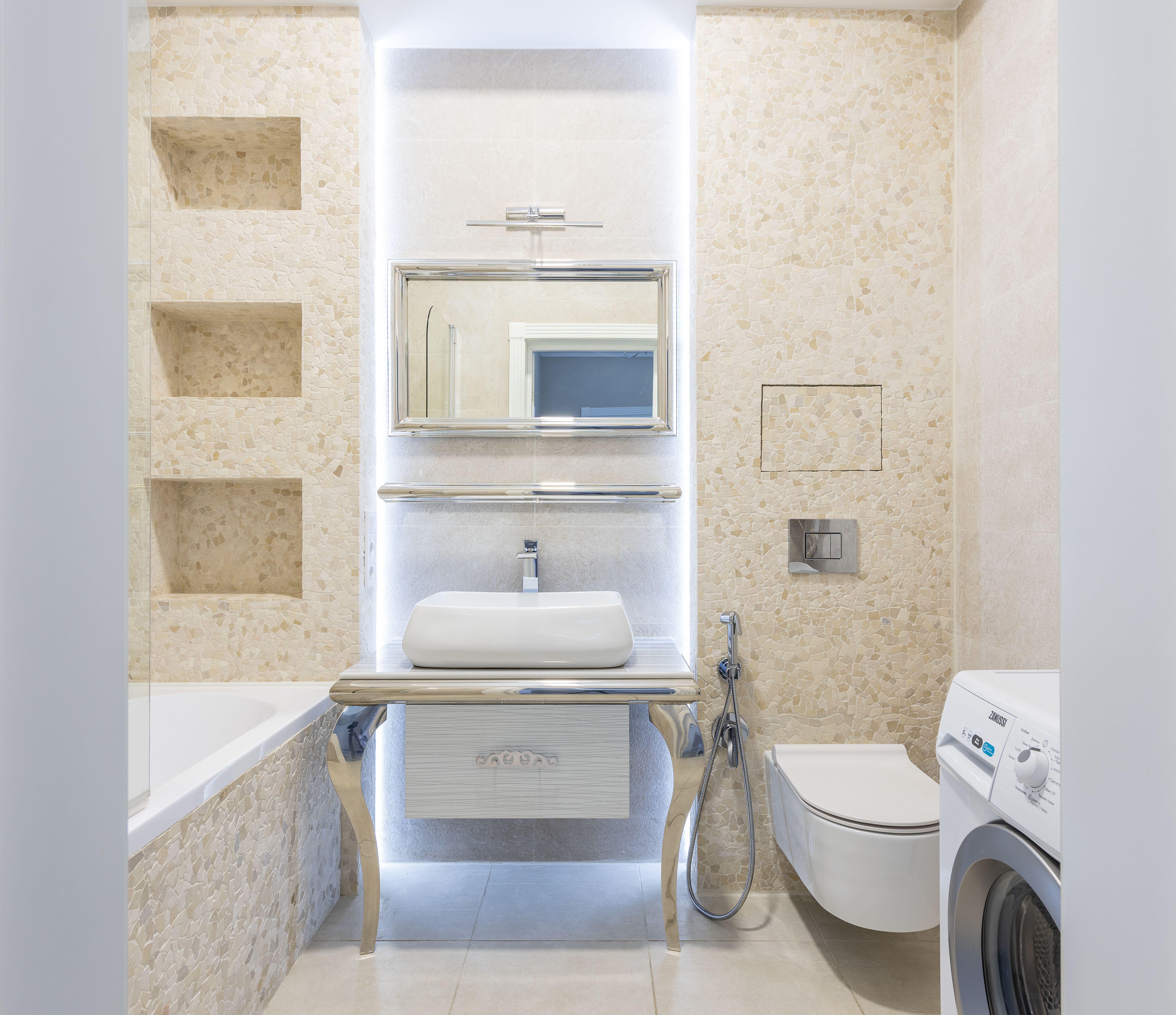 UK plumber's tools and fittings laid out next to a toilet showing T-connector installation components