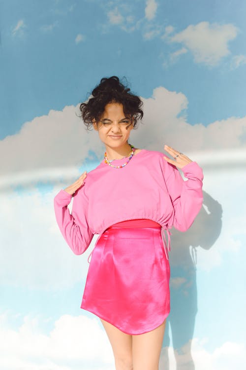 Woman Posing in Pink Blouse and Skirt