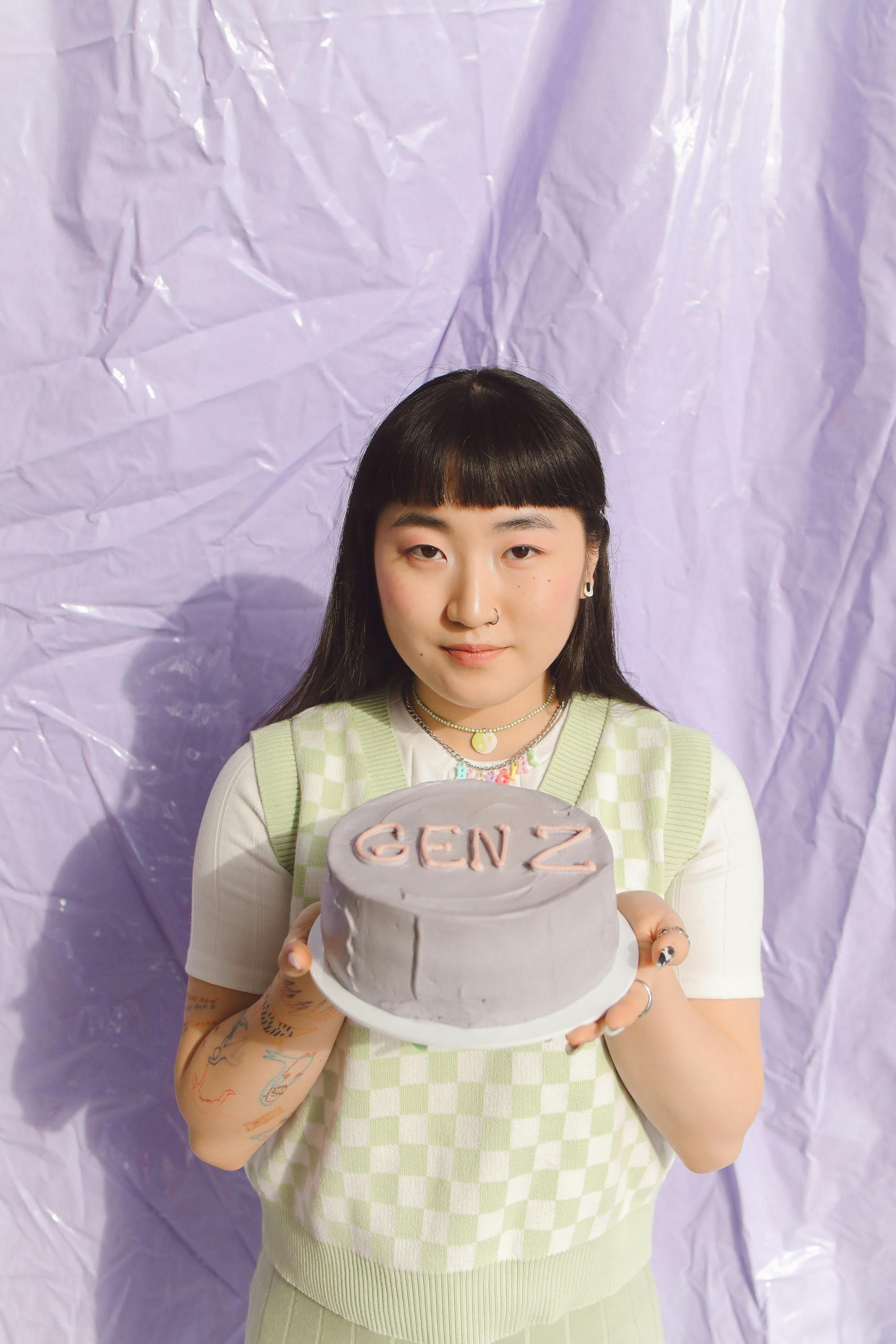 woman holding a purple cake