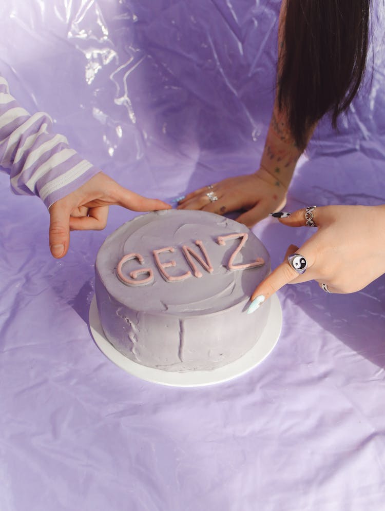 People Touching A Minimalist Cake