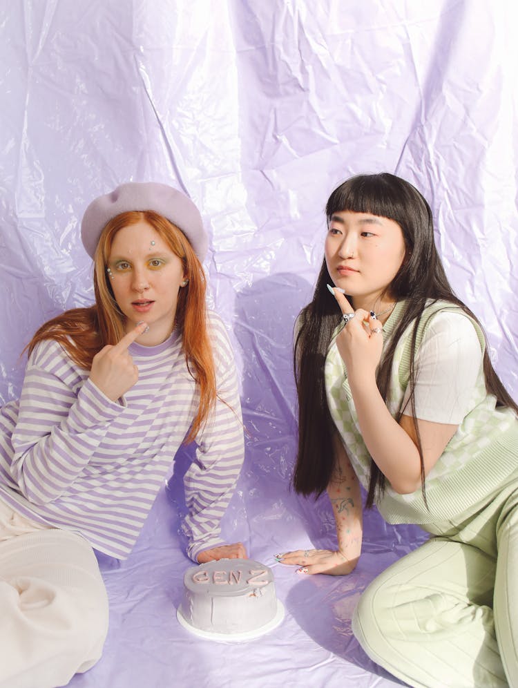 Women Showing Their Fingers With Cake Icing