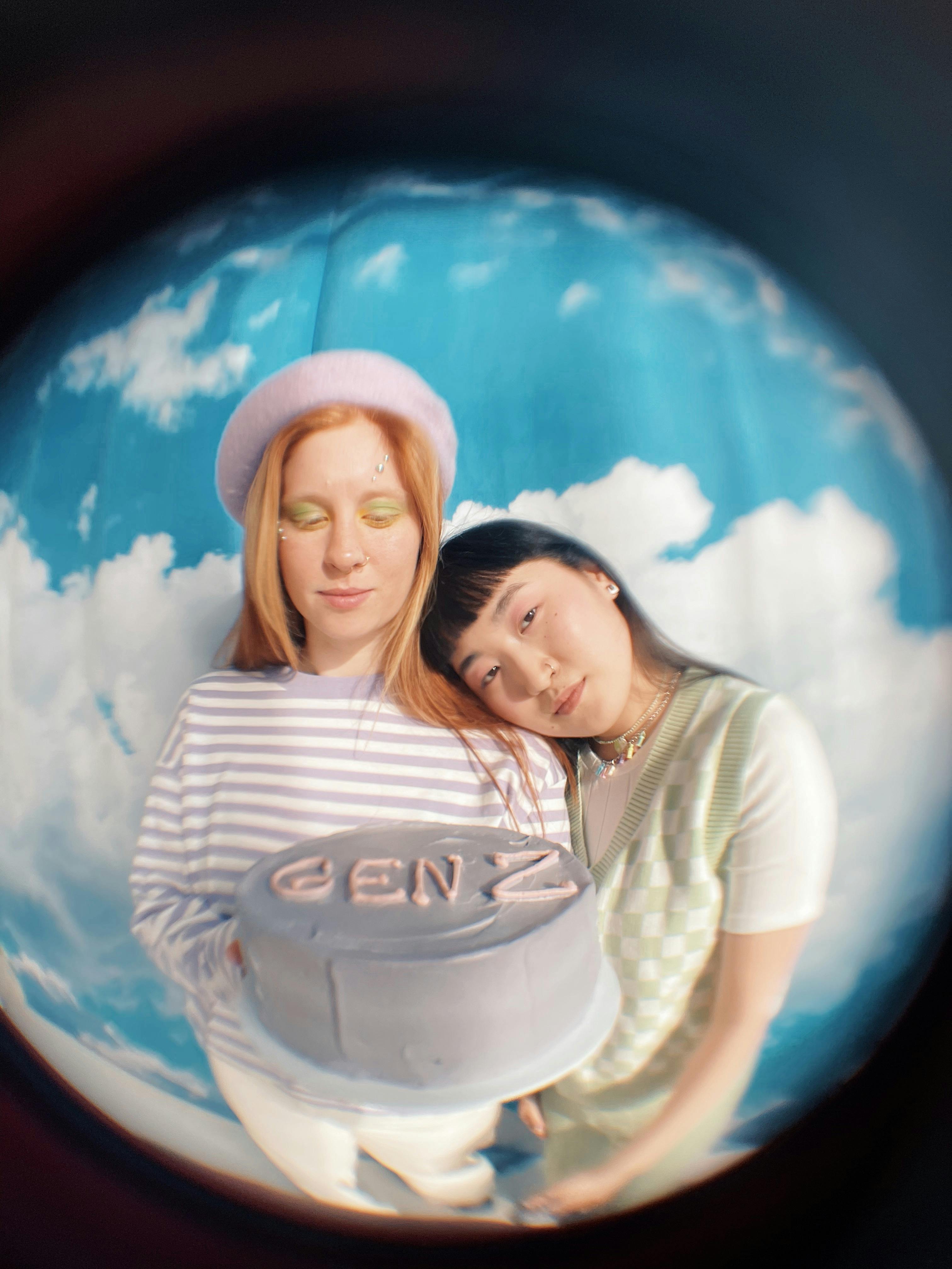 fisheye photo of a teenagers holding a gen z cake