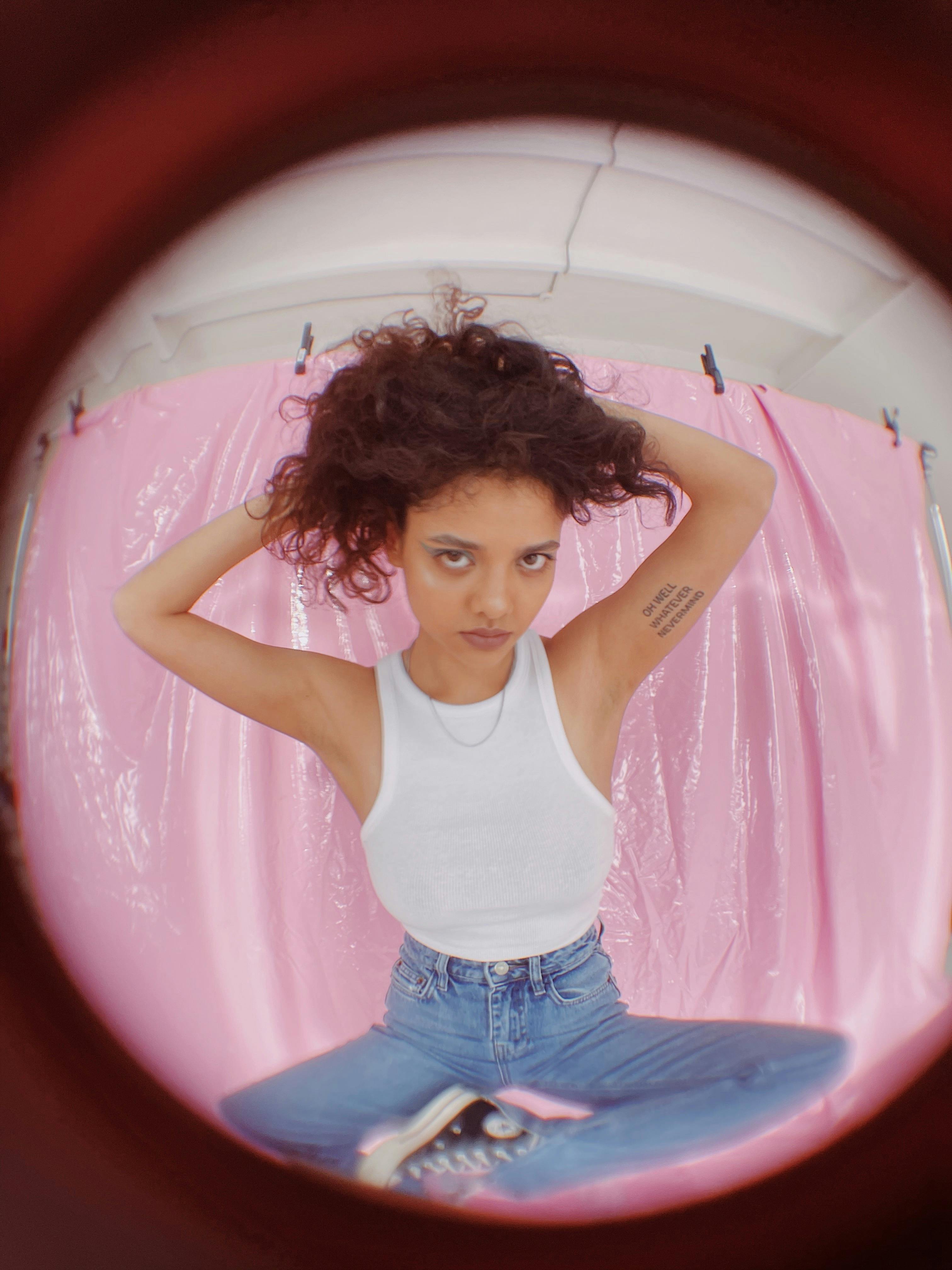 photograph of a girl touching her curly hair