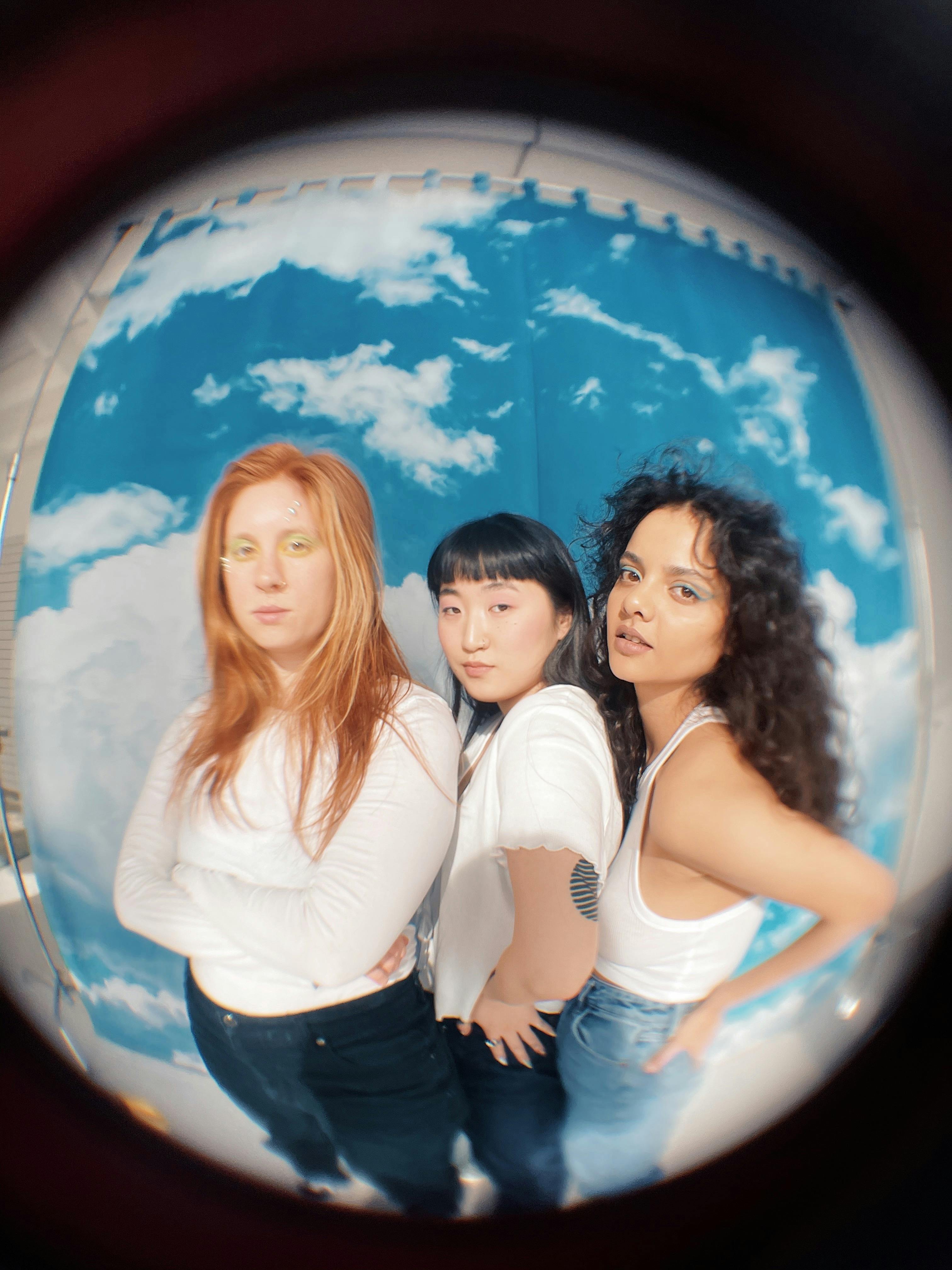 fisheye photo of three girls posing and looking at the camera