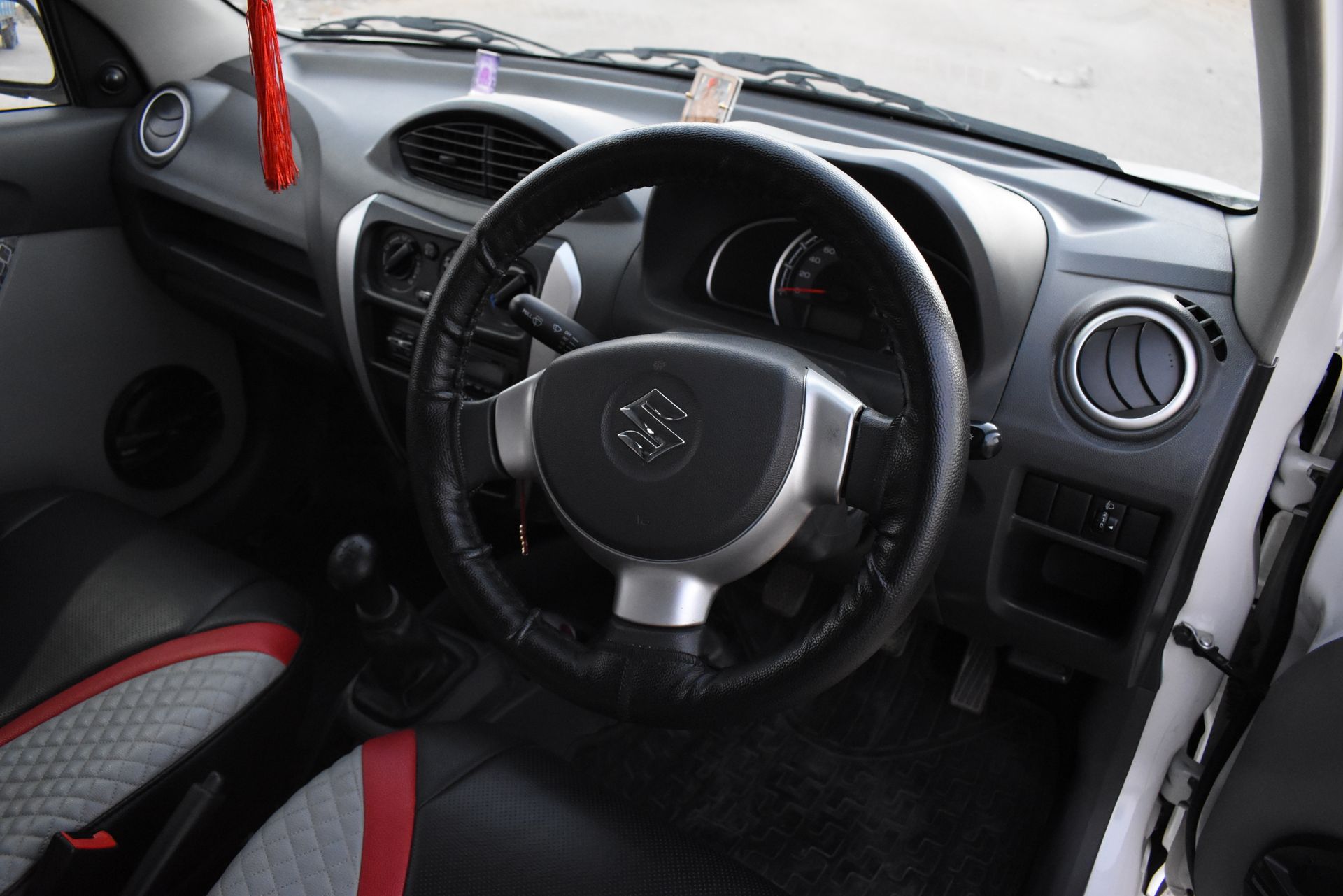 Interior view of a car featuring a steering wheel and dashboard with a stylish design.