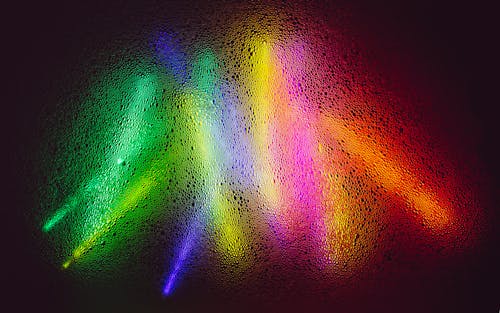 Colorful Glowing Sticks Behind Frosted Glass