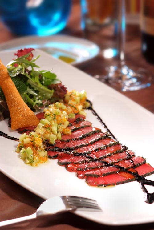 Sliced Meats with Vegetables on the Side on a White Ceramic Plate