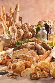 A variety of freshly baked bread and ingredients displayed in a warm, inviting setting.