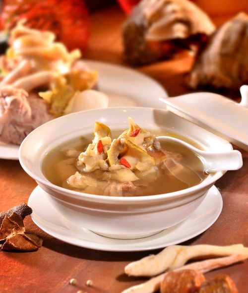 Free Flavorful Asian herbal chicken soup served in a traditional white bowl, showcasing rich ingredients and textures. Stock Photo