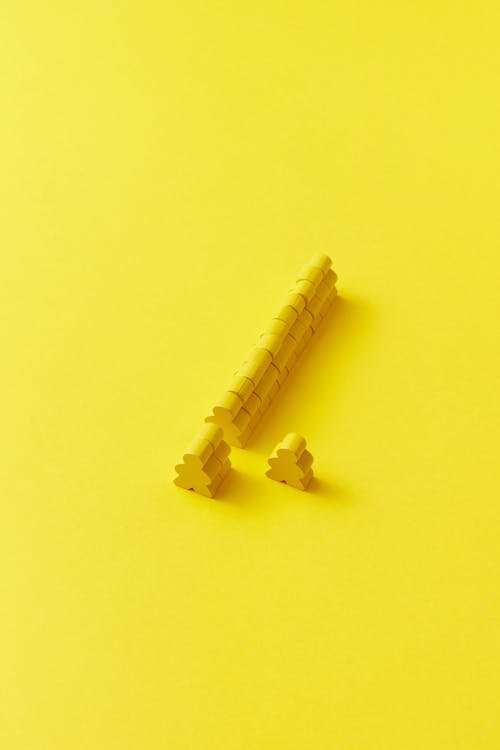 Photograph of Meeples on a Yellow Surface