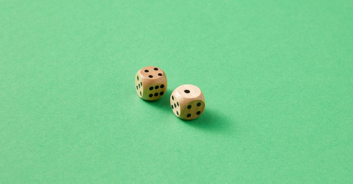 Close-up of two wooden dice on a vibrant green background. - Evidence evidence guide for sage cognition randomized trial