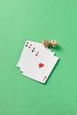 Four Aces Beside Wooden Dices on a Green Surfacae