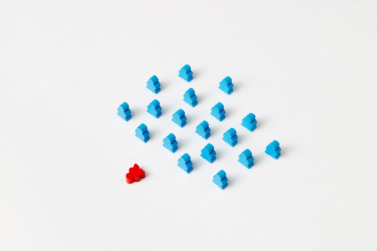 A distinctive red game piece standing out among blue pieces, symbolizing differentiation