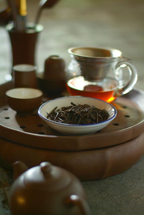 Free Close-up of a tea setup featuring loose leaves and teapots, embodying traditional elements. Stock Photo