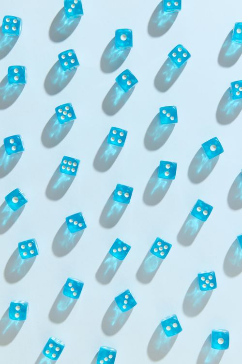 Free Blue dice arranged on a light background with long shadows, creating a geometric and artistic pattern. Stock Photo