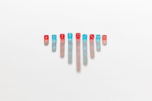 Free Red and blue dice arranged symmetrically casting elongated shadows on a white surface. Stock Photo