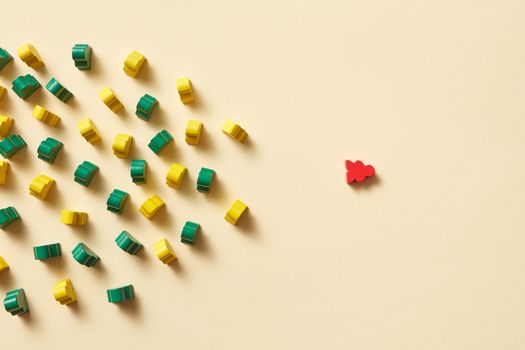 Arranged green, yellow, and red toy pieces on yellow background. Unique arrangement concept.