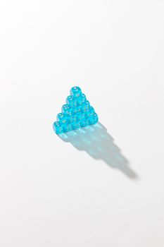 A creative arrangement of transparent blue dice stacked in a pyramid shape on a white background.